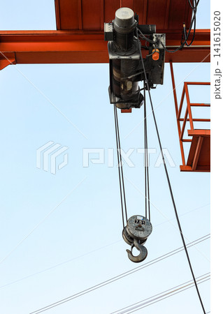 Red 7.5 Tons Industrial hook with chains or chain hoist on duty at construction site. Red 7.5 Tons Industrial hook with chains or chain hoist on duty at construction site. 141615020