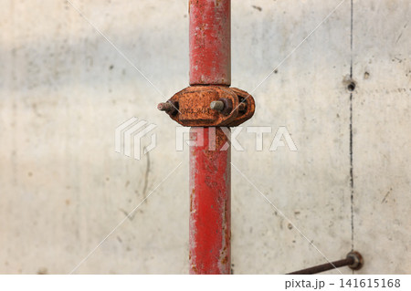 Close up old steel metal pipe of Fire extinguishing system attached to the wall in Construction. Close up old steel metal pipe of Fire extinguishing system attached to the wall in Construction. 141615168