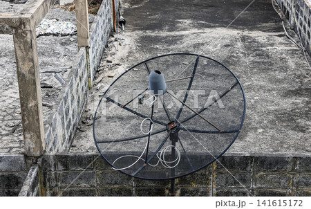 Abandon or Broken antenna communication satellite dish on top of old building. Abandon or Broken antenna communication satellite dish on top of old building. 141615172
