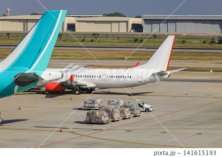 Baggage Tug( baggage dolly transport ) on duty in ground handling services. 141615193