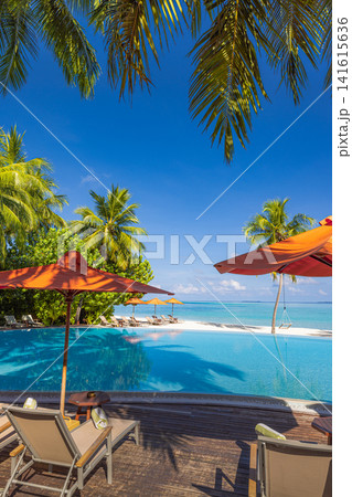Elegant tropical infinity pool with red umbrella and loungers framed by palm trees turquoise ocean blue sky. Perfect summer vacation travel resort paradise. Luxury getaway relax scenic Elegant tropical infinity pool with red umbrella and loungers framed by palm trees turquoise ocean blue sky. Perfect summer vacation travel resort paradise. Luxury getaway relax scenic 141615636