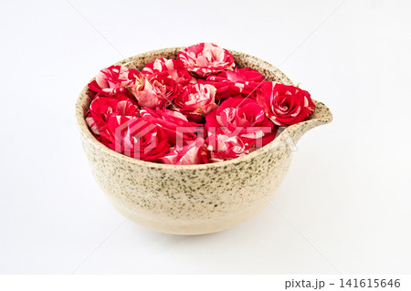 Ceramic bowl filling with vibrant red and white roses Ceramic bowl filling with vibrant red and white roses 141615646