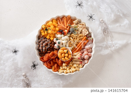 Halloween dessert platter with spooky candy on white background top view Halloween dessert platter with spooky candy on white background top view 141615704