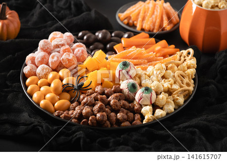 Halloween sweet snack platter with candy popcorn and spooky treats Halloween sweet snack platter with candy popcorn and spooky treats 141615707