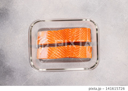 Fresh raw salmon fillets in glass container Fresh raw salmon fillets in glass container 141615726
