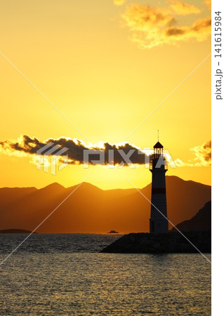 Seascape at sunshine. Lighthouse and sailings on the coast. Seaside town of Turgutreis and spectacular sunshine Seascape at sunshine. Lighthouse and sailings on the coast. Seaside town of Turgutreis and spectacular sunshine 141615984