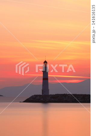 Seascape at sunshine. Lighthouse and sailings on the coast. Seaside town of Turgutreis and spectacular sunshine Seascape at sunshine. Lighthouse and sailings on the coast. Seaside town of Turgutreis and spectacular sunshine 141616135
