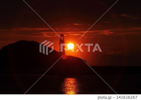 Seascape at sunshine. Lighthouse and sailings on the coast. Seaside town of Turgutreis and spectacular sunshine Seascape at sunshine. Lighthouse and sailings on the coast. Seaside town of Turgutreis and spectacular sunshine 141616267