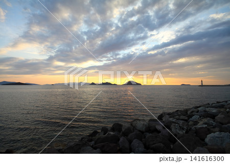 Seascape at sunshine. Lighthouse and sailings on the coast. Seaside town of Turgutreis and spectacular sunshine 141616300