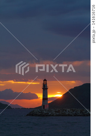 Seascape at sunshine. Lighthouse and sailings on the coast. Seaside town of Turgutreis and spectacular sunshine 141616716
