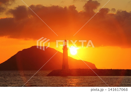 Seascape at sunshine. Lighthouse and sailings on the coast. Seaside town of Turgutreis and spectacular sunshine Seascape at sunshine. Lighthouse and sailings on the coast. Seaside town of Turgutreis and spectacular sunshine 141617068