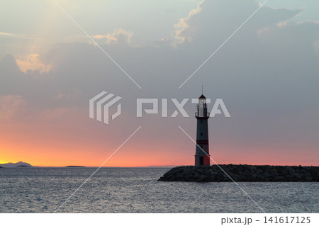Seascape at sunshine. Lighthouse and sailings on the coast. Seaside town of Turgutreis and spectacular sunshine 141617125