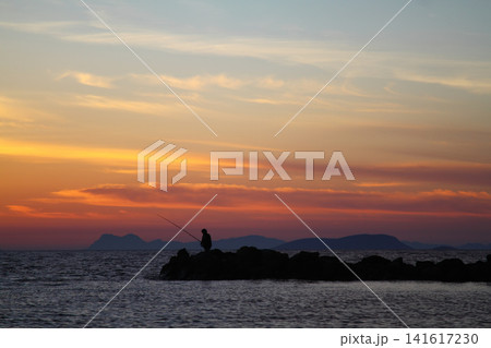 Tourists on holiday in the famous resort town of Bodrum spend time fishing at sunset. Tourists on holiday in the famous resort town of Bodrum spend time fishing at sunset. 141617230