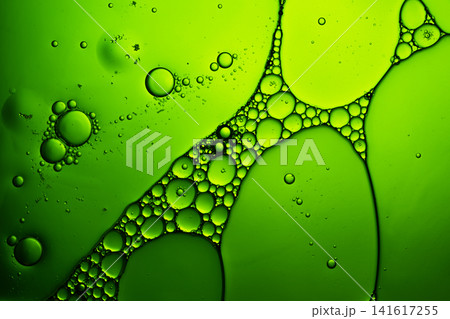 Oil and water separation forming a vibrant green bubble pattern surface Oil and water separation forming a vibrant green bubble pattern surface 141617255