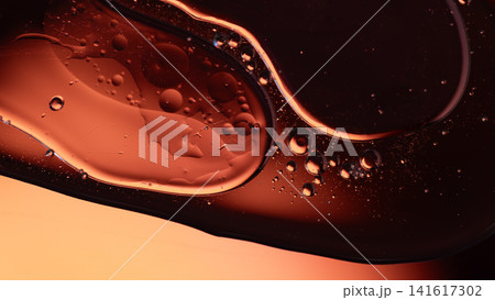 Abstract orange and red oil droplets suspended in liquid creating an interesting texture background Abstract orange and red oil droplets suspended in liquid creating an interesting texture background 141617302