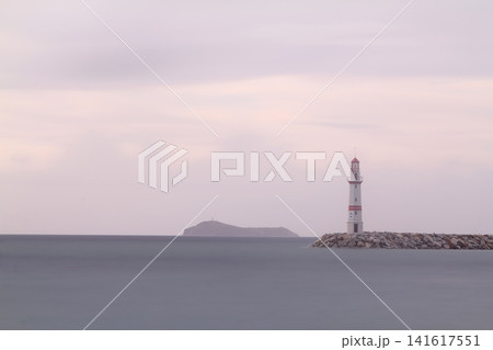 Seascape at sunshine. Lighthouse and sailings on the coast. Seaside town of Turgutreis and spectacular sunshine Seascape at sunshine. Lighthouse and sailings on the coast. Seaside town of Turgutreis and spectacular sunshine 141617551