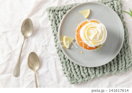 Lemon cupcake with white frosting from top view Lemon cupcake with white frosting from top view 141617614