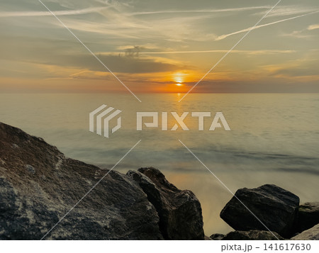 Golden sunset over rocky Furadouro beach Ovar view Golden sunset over rocky Furadouro beach Ovar view 141617630