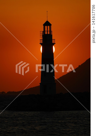 Seascape at sunshine. Lighthouse and sailings on the coast. Seaside town of Turgutreis and spectacular sunshine Seascape at sunshine. Lighthouse and sailings on the coast. Seaside town of Turgutreis and spectacular sunshine 141617786