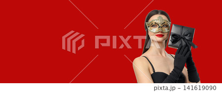 Woman in black with gloves holding a gift Woman in black with gloves holding a gift 141619090