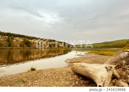 Calm warm autumn day at the river among yellow forests. Calm warm autumn day at the river among yellow forests. 141619666