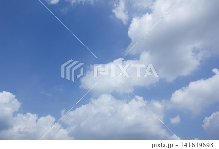 It is a blue sky with fluffy clouds. It is a blue sky with fluffy clouds. 141619693