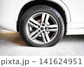 Close-up of a flat tire on a white modern car parked on a concrete floor 141624951