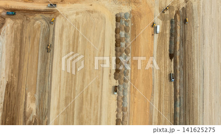 Aerial view motor grader civil at construction site, Motor grader work on construction site, Road grader on road construction site machine work on the construction of new road. 141625275