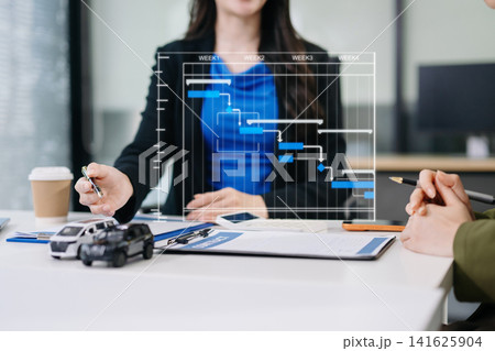 Business executives analyzing car manufacturing schedules or dealership timelines using a futuristic digital Gantt chart interface. 141625904