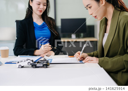Client signing a car insurance contract after an auto accident claim. Secure vehicle protection 141625914