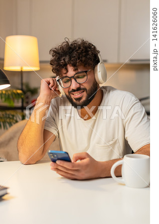 Arabian man in wireless headphones leans back listens chill music eyes closed slow nod enjoys peace Arabian man in wireless headphones leans back listens chill music eyes closed slow nod enjoys peace 141626060