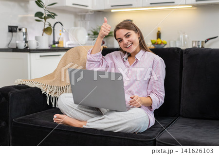 Young woman says wow lifts arms with laptop celebrates win positive news sparks joy proud reaction Young woman says wow lifts arms with laptop celebrates win positive news sparks joy proud reaction 141626103