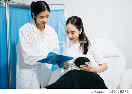 Doctor consulting patient in beauty clinic, skincare analysis, aesthetic treatment planning, professional advice, clean medical setting, modern cosmetic care Doctor consulting patient in beauty clinic, skincare analysis, aesthetic treatment planning, professional advice, clean medical setting, modern cosmetic care 141626278