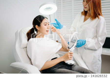 Dermatologist Injecting Botox or Facial Filler Treatment for Young Asian Woman at Aesthetic Clinic Dermatologist Injecting Botox or Facial Filler Treatment for Young Asian Woman at Aesthetic Clinic 141626532