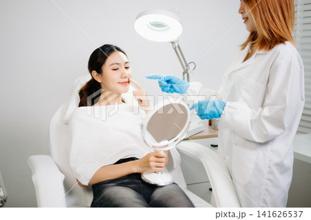 Dermatologist Injecting Botox or Facial Filler Treatment for Young Asian Woman at Aesthetic Clinic Dermatologist Injecting Botox or Facial Filler Treatment for Young Asian Woman at Aesthetic Clinic 141626537