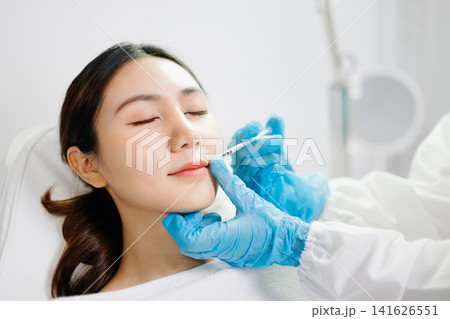 Dermatologist Injecting Botox or Facial Filler Treatment for Young Asian Woman at Aesthetic Clinic Dermatologist Injecting Botox or Facial Filler Treatment for Young Asian Woman at Aesthetic Clinic 141626551