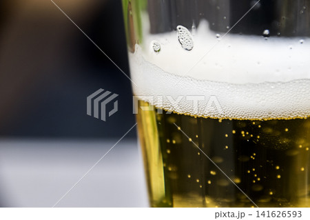 Close Up of Golden Beer with Frothy Head and Bubbles Rising Close Up of Golden Beer with Frothy Head and Bubbles Rising 141626593