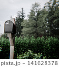 black mailbox on a wooden post 141628378