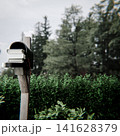 black mailbox on a wooden post 141628379