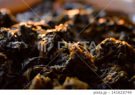 Close Up Of Delicious Slow Cooked Spinach With Saturated Oil And Herbs Close Up Of Delicious Slow Cooked Spinach With Saturated Oil And Herbs 141628749