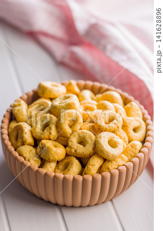 Italian Taralli Snack Rings In Ceramic Bowl With Olive Oil And Pink Checkered Cloth Italian Taralli Snack Rings In Ceramic Bowl With Olive Oil And Pink Checkered Cloth 141628896