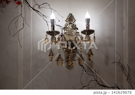 Vintage Crystal Wall Sconce with Smoky Brown Crystal Pendants in Elegant Luxury Interior. Vintage Crystal Wall Sconce with Smoky Brown Crystal Pendants in Elegant Luxury Interior. 141629078