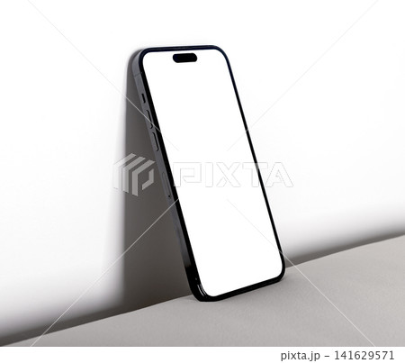 Blank smartphone mockup leaning on a white surface. Minimal mobile phone with copy space in a clean studio setup. Ideal for app advertising, UI design, and product branding.. 141629571