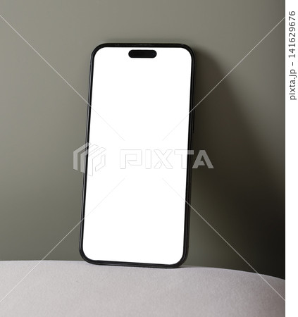 Smartphone mockup with blank white screen on a minimalist background. Vertical mobile phone in a clean studio setup with copy space. Ideal for app design, advertising, and 141629676
