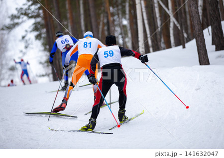 Rear view three athletes skiers Rear view three athletes skiers 141632047