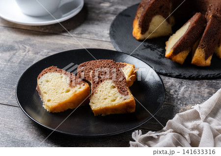 Marble bundt cake sliced on rustic wooden table Marble bundt cake sliced on rustic wooden table 141633316