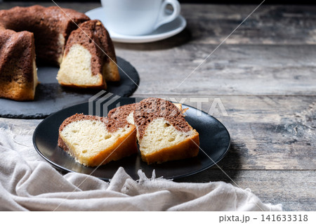 Marble bundt cake sliced on rustic wooden table 141633318