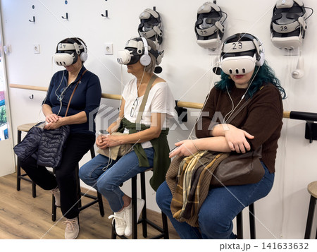 Three women experiencing virtual reality together 141633632