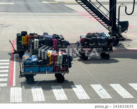 Luggage carts loaded for airport ground handling Luggage carts loaded for airport ground handling 141633635