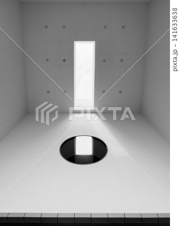 Circular mirror aligned with bright rectangular skylight Circular mirror aligned with bright rectangular skylight 141633638